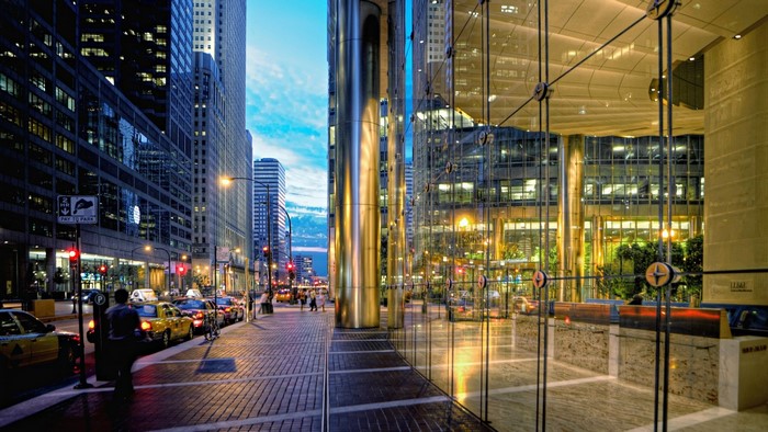 City street at dusk with skyscrapers and taxis