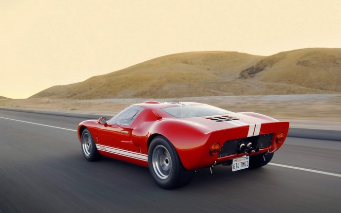 Red Ford GT40 driving on a road