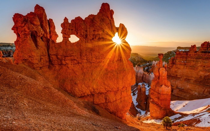 Sunrise through rock arch in Bryce Canyon National Park