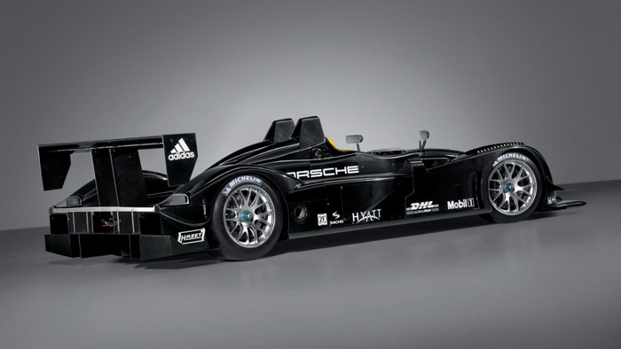 Black Porsche race car with Adidas and Michelin logos