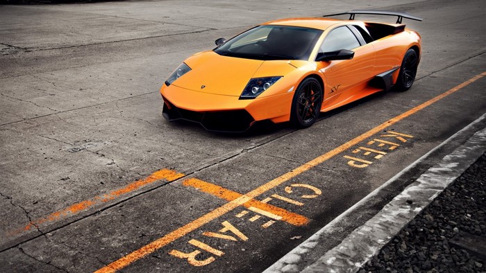 Orange Lamborghini Gallardo parked on asphalt