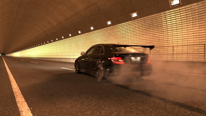 Black Mercedes Benz C63 AMG drifting in a tunnel
