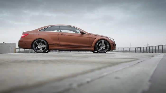 Matte brown Mercedes-Benz E-Class Coupe on a rooftop
