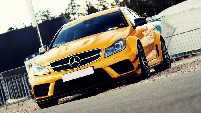 Yellow Mercedes-Benz C63 AMG Coupe parked outdoors