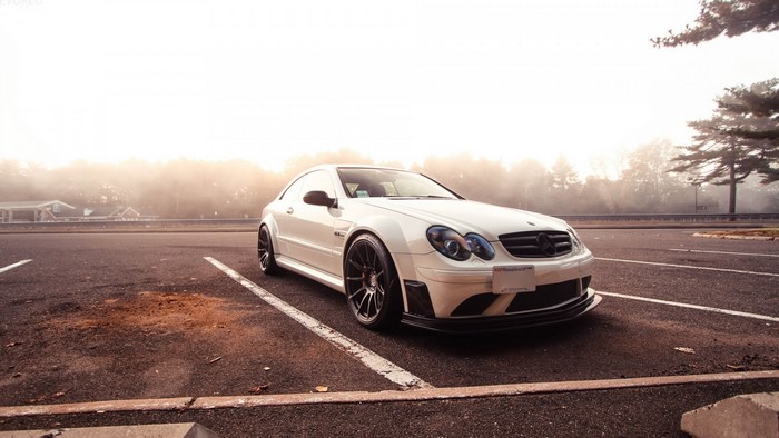 White Mercedes-Benz CLK Class parked in a foggy lot