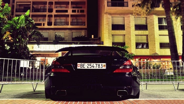 Black Mercedes-Benz SL with Swiss license plate at night