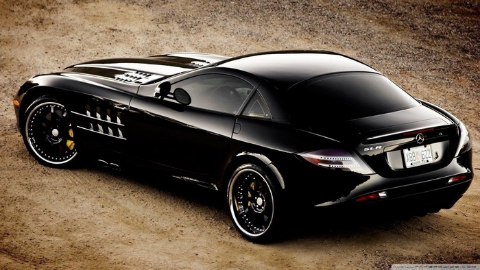 Black Mercedes-Benz SLR McLaren sports car on dirt road
