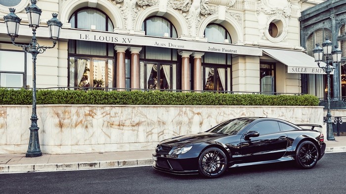 Black Mercedes-Benz SL-Class parked in front of Le Louis XV restaurant