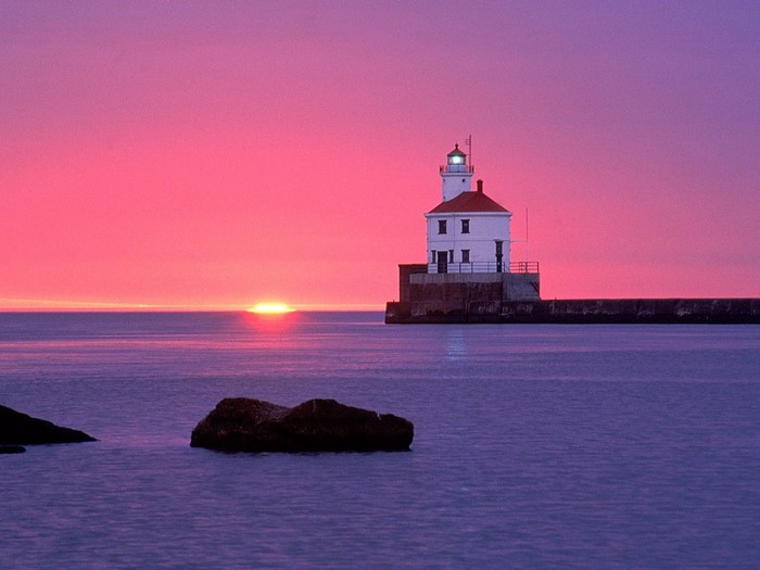 Lighthouse at sunset over the ocean