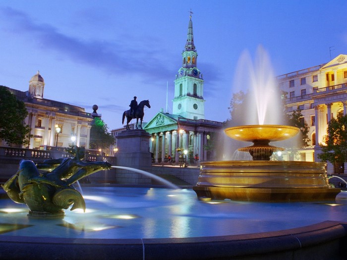 Trafalgar Square fountain and St Martin-in-the-Fields church at dusk
