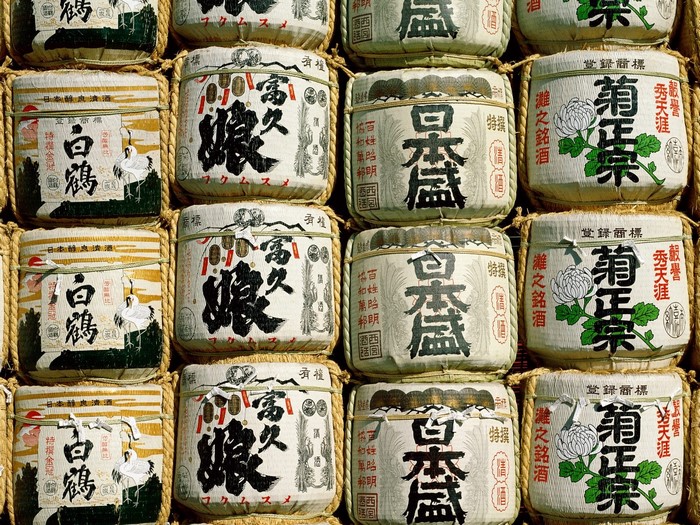 Japanese sake barrels with calligraphy and illustrations