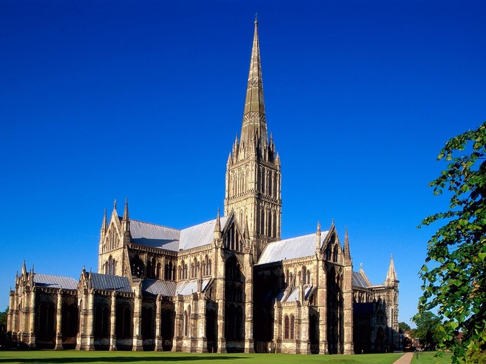 Salisbury Cathedral with a tall spire under a blue sky
