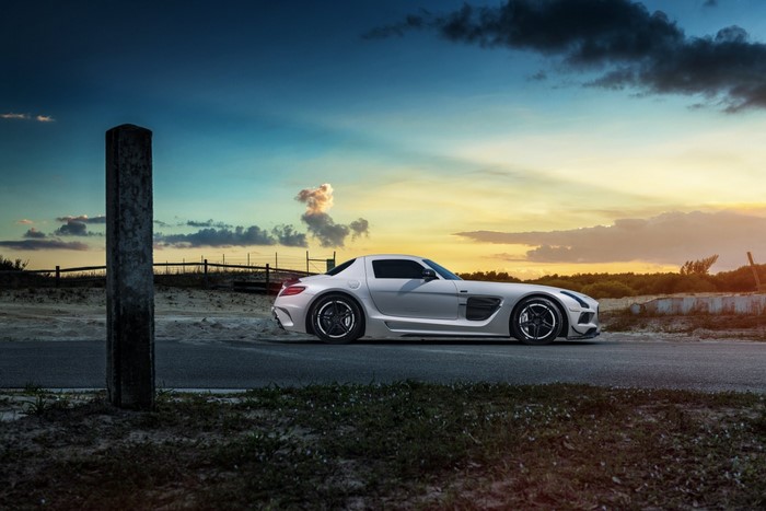 Mercedes Benz SLS AMG on a road at sunset