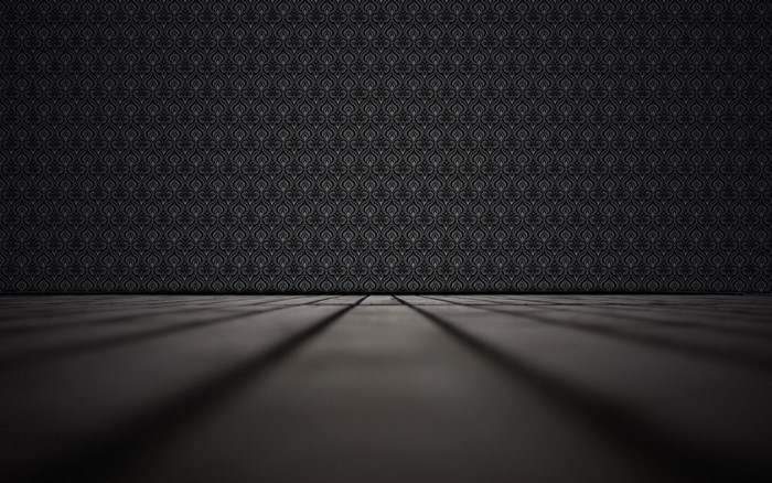 Dark patterned wall and floor with shadows