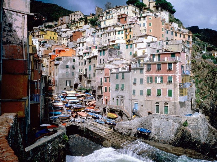 Colorful Italian village with boats on a waterway