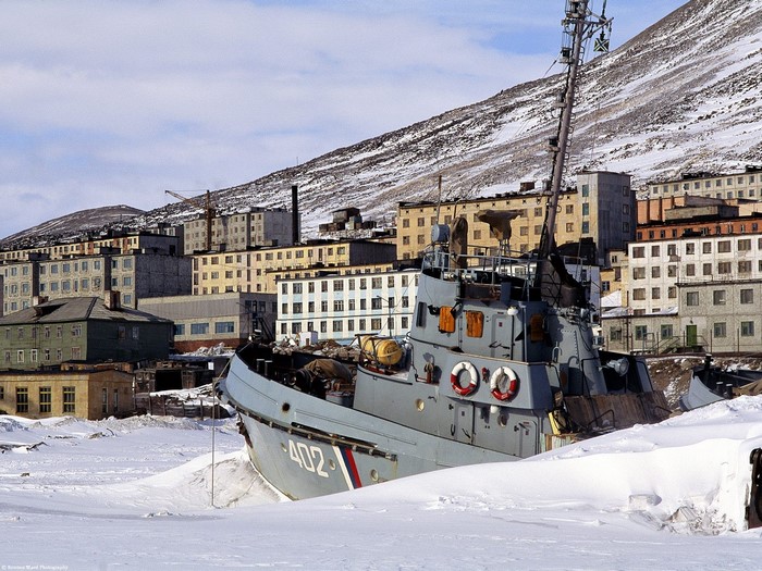 Shipwrecked vessel in a snowy Arctic town