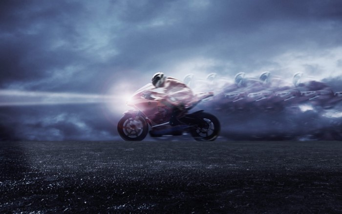 Motorcycle racer with motion blur in dark clouds