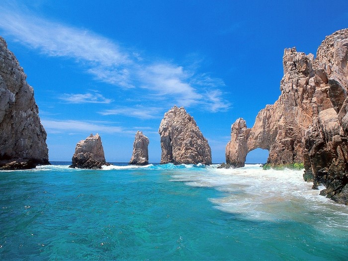Rocky coast with natural arch and turquoise ocean