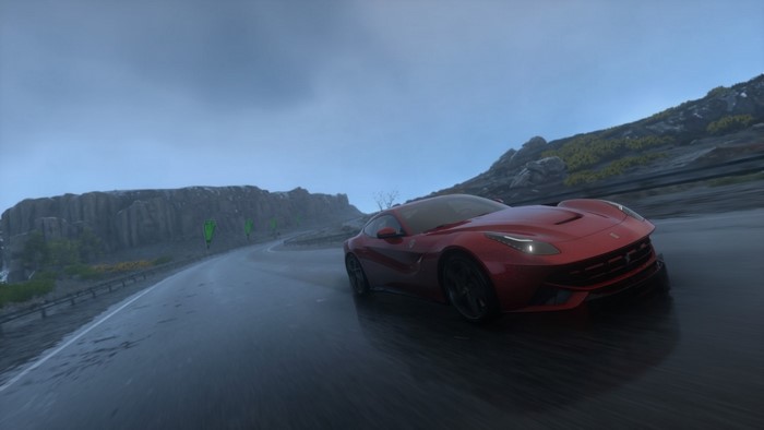 Red Ferrari F12berlinetta driving on a wet road