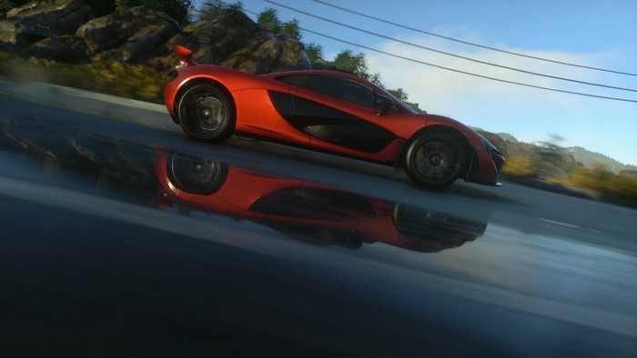 Orange McLaren P1 driving on a wet road