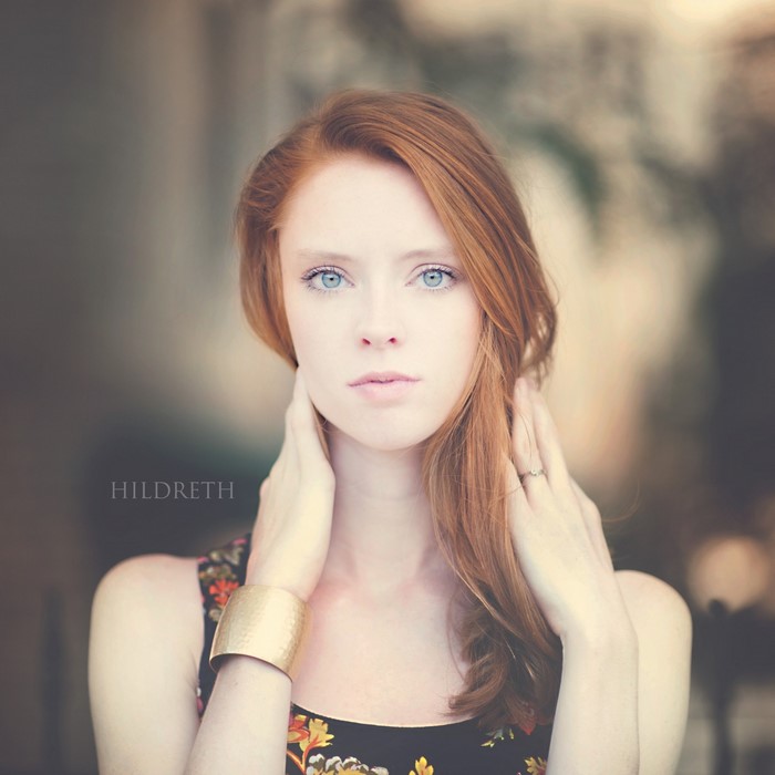 Redhead woman with blue eyes and floral dress
