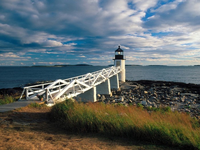 Lighthouse with a white walkway over the sea