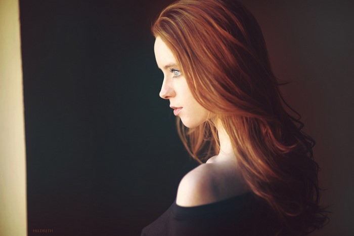 Woman with long red hair in profile