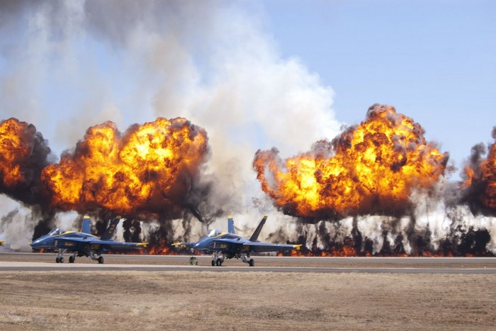 Blue Angels F/A-18 Hornets with large explosions