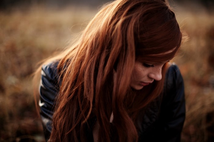 Redhead woman with freckles and long hair