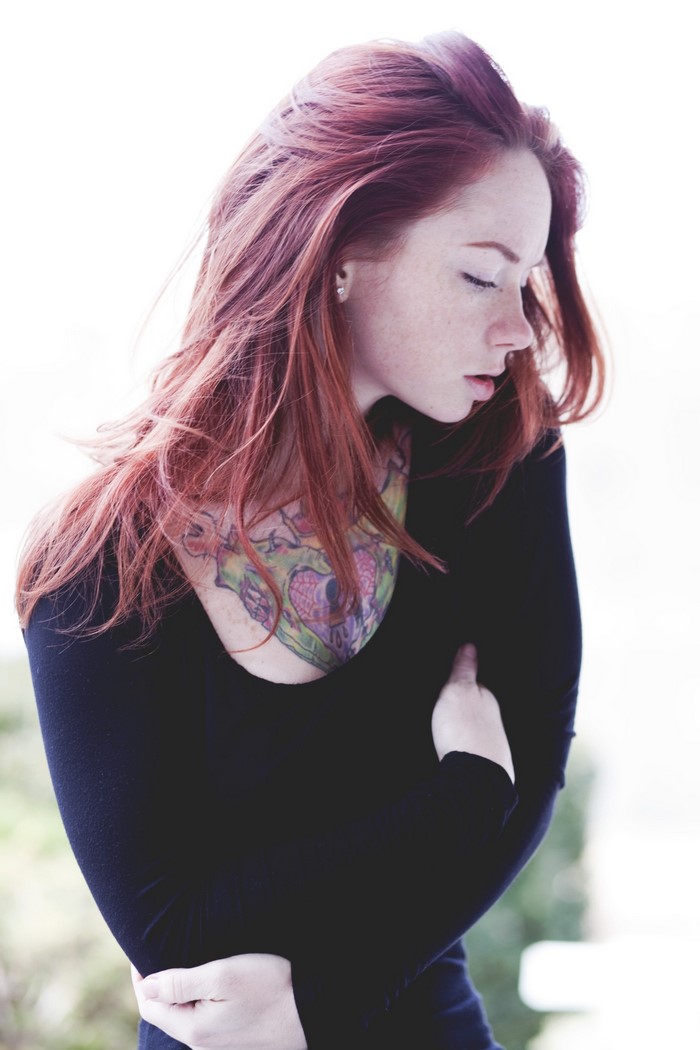 Woman with red hair and tattoo
