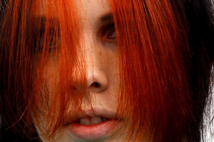 Close up of a woman with red and black hair
