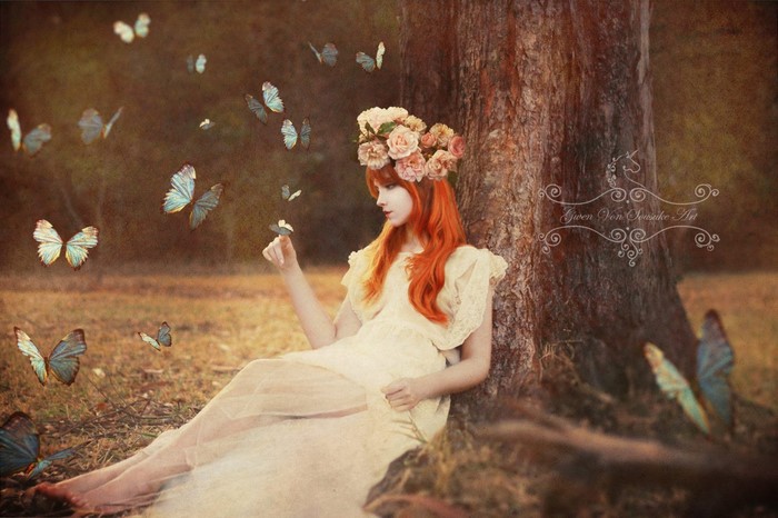 Redhead woman with flower crown and butterflies