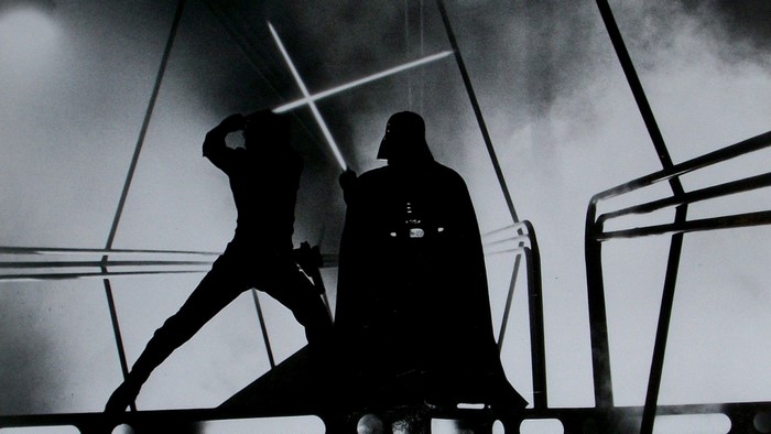 Luke Skywalker and Darth Vader duel with lightsabers