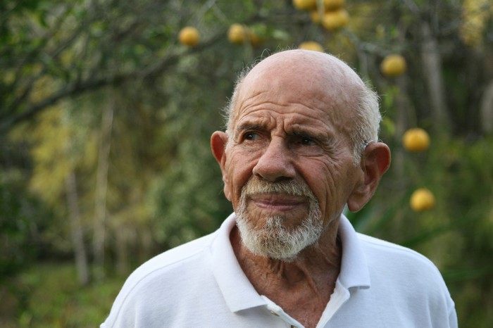 Elderly man with beard and white shirt
