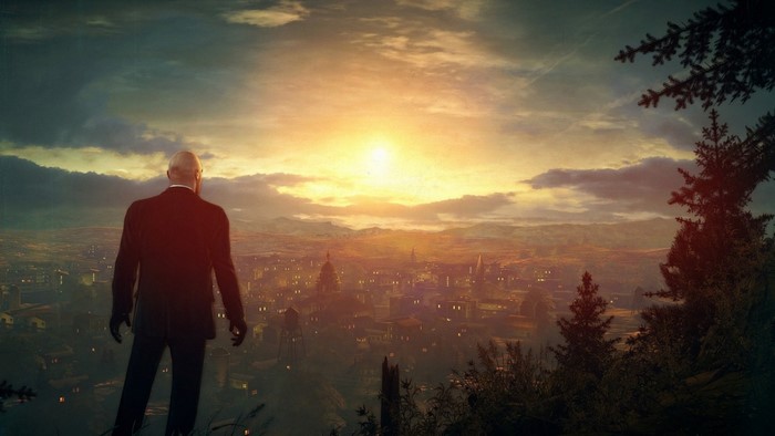 Agent 47 from Hitman overlooking a city at sunset