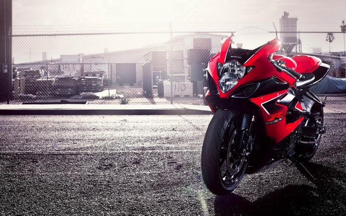 Red Suzuki GSX-R motorcycle parked on asphalt