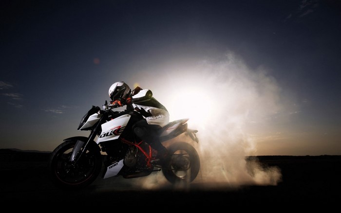 KTM motorcycle rider performing a burnout