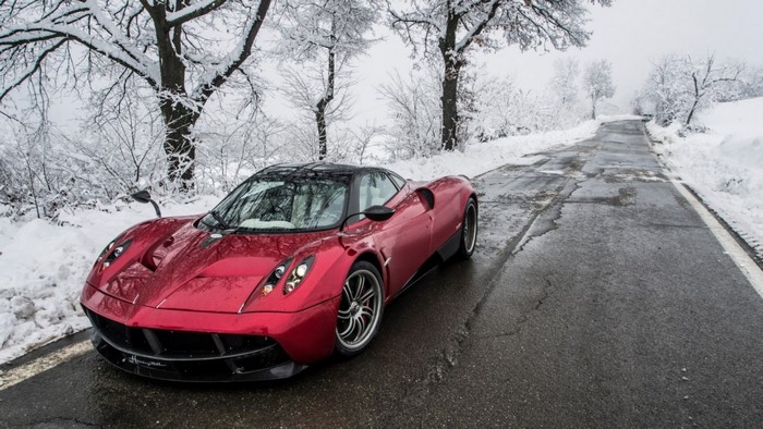 Red Pagani Huayra on a snowy road