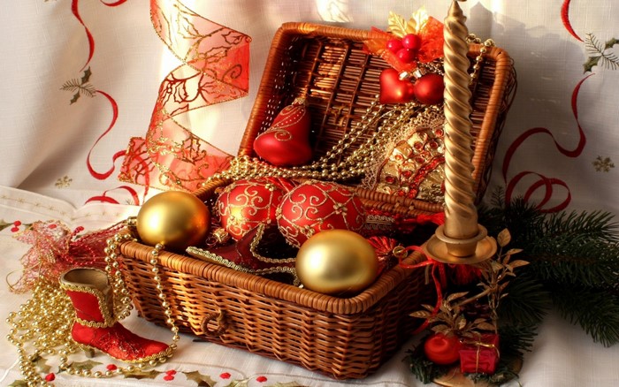 Christmas ornaments and candle in a basket