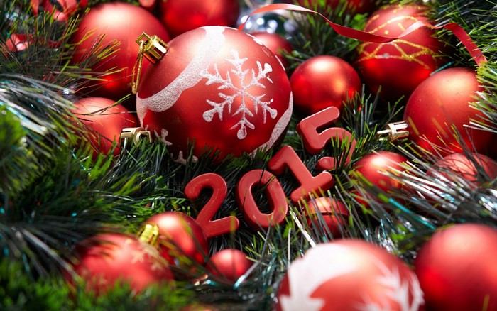 Christmas ornaments and 2015 numbers on a fir branch