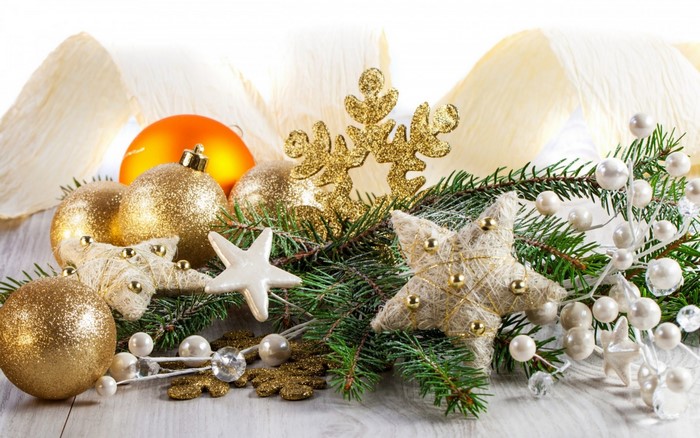 Christmas ornaments and pine branches on a wooden surface