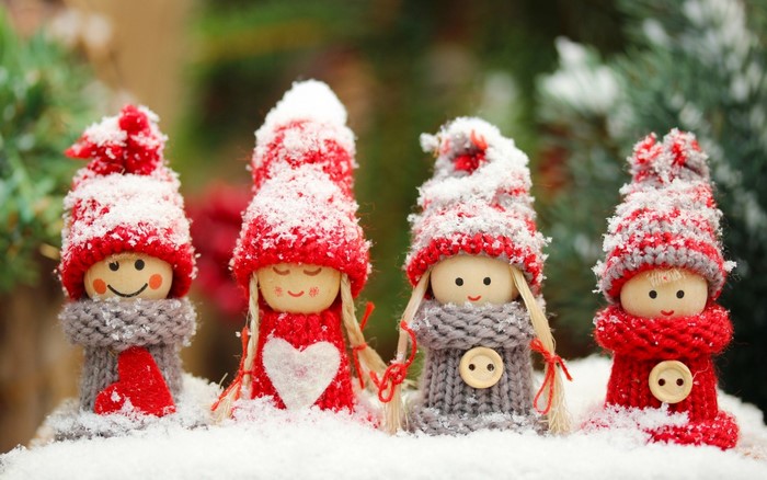 Four Christmas gnomes in the snow