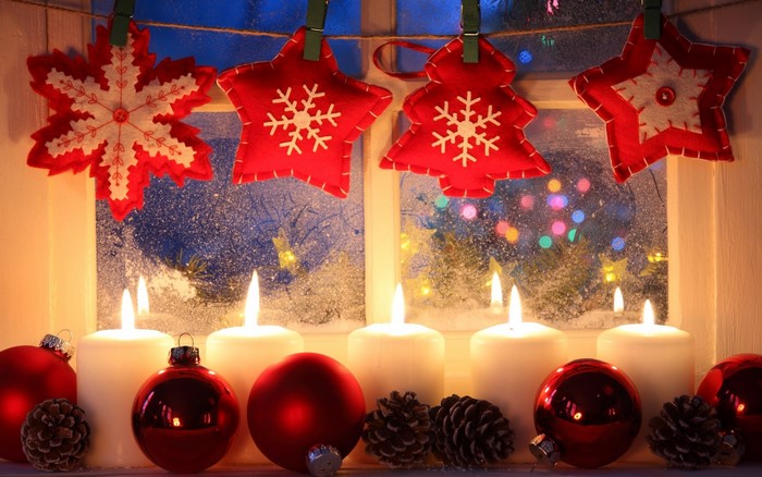 Christmas window decorations with candles and ornaments
