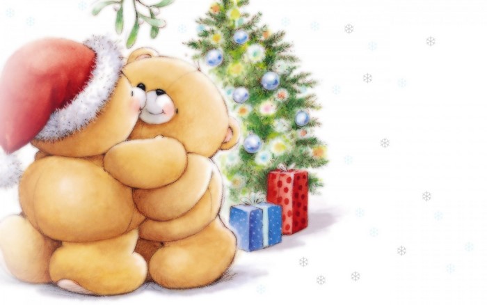 Two teddy bears in Santa hats by a Christmas tree