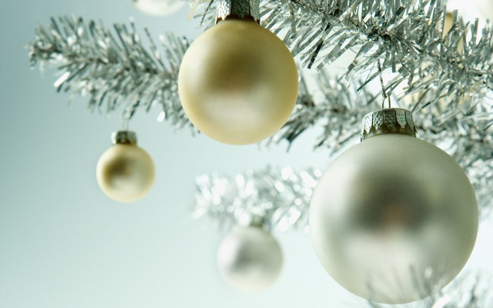 Christmas ornaments on a silver tinsel branch
