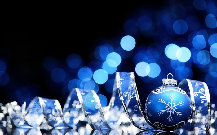 Blue Christmas ornament with ribbon and bokeh lights