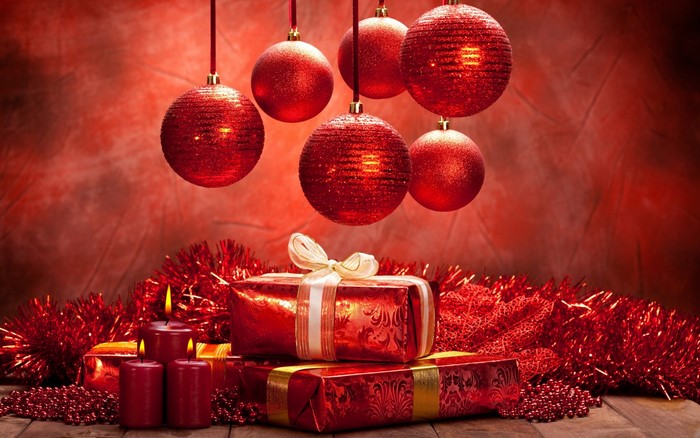 Red Christmas ornaments and gifts with candles