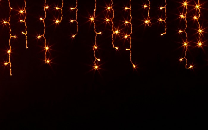 String of orange lights on black background