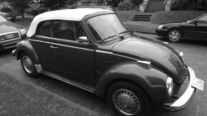 Black Volkswagen Beetle Convertible parked on street