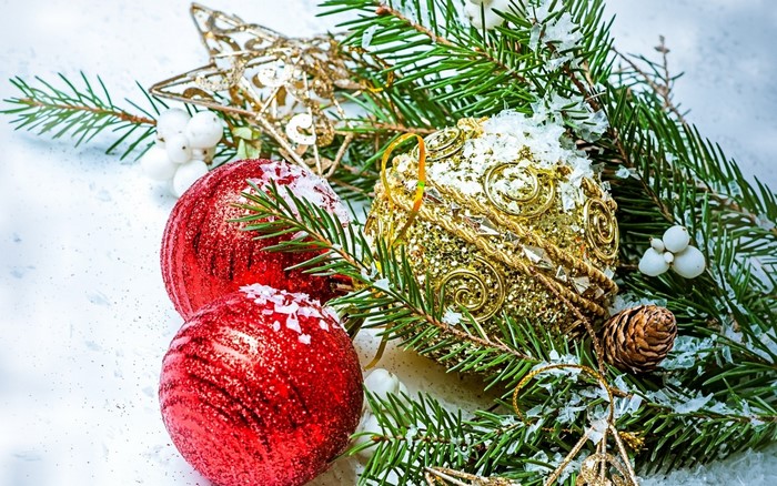Christmas ornaments on spruce branches with snow